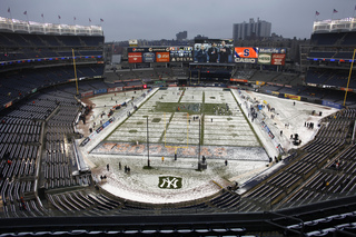 Snow begins to mix with rain, and seats remain empty about an hour before kickoff.  Syracuse takes on West Virginia in the 2012 Pinstripe Bowl at a snowy Yankee Stadium on Saturday, Dec. 29, 2012, in New York City.
