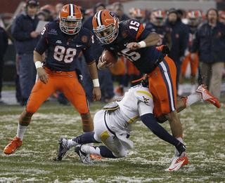 Syracuse wide receiver Alec Lemon #15 is tripped up in the first half.  Syracuse takes on West Virginia in the 2012 Pinstripe Bowl at a snowy Yankee Stadium on Saturday, December 29, 2012 in New York, New York.