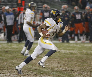 Trevon Austin #1, wide receiver for West Virginia, runs the ball up the field.  Syracuse takes on West Virginia in the 2012 Pinstripe Bowl at a snowy Yankee Stadium on Saturday, December 29, 2012 in New York, New York.