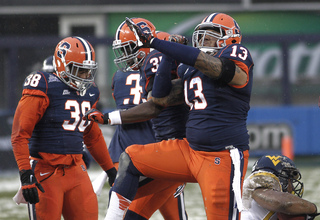 Deon Goggins #13, a tackle for Syracuse, celebrates after a tackle behind the line of scrimmage.  Syracuse takes on West Virginia in the 2012 Pinstripe Bowl at a snowy Yankee Stadium on Wednesday, December 26, 2012 in New York, New York.