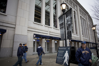 West Virginia fans wait outside in the snow for Yankee Stadium to open to the public. Syracuse takes on West Virginia in the 2012 Pinstripe Bowl at a snowy Yankee Stadium on Saturday, Dec. 29, 2012, in New York City. 
