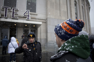 A Syracuse fan is greeted by a disapproving West Virginia fan outside Gate 4 at Yankee Stadium before it opens to the public. Syracuse takes on West Virginia in the 2012 Pinstripe Bowl at a snowy Yankee Stadium on Saturday, Dec. 29, 2012, in New York City. 