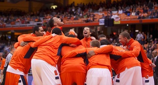 Syracuse University's DaJuan Coleman howls from the middle of the pregame huddle prior to tipoff Thursday night in the Carrier Dome.