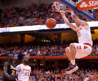 Syracuse University guard Trevor Cooney finishes an emphatic breakaway dunk during the Orange's rout of Long Beach State Thursday at the Carrier Dome. Cooney made 4-of-9 shots for 11 points in the Syracuse victory.