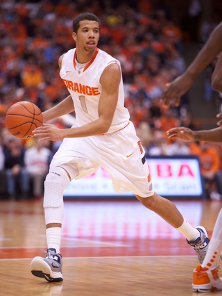 Syracuse University guard Michael Carter-Williams dribbles off a screen and looks for an open lane to drive.