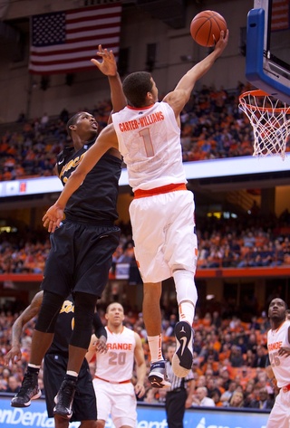 Syracuse University guard Michael Carter-Williams elevates and attempts the layup over Long Beach State forward Dan Jennings.
