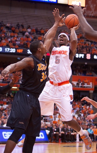 Syracuse University forward C.J. Fair is fouled by Long Beach State's Dan Jennings while shooting a layup during the second half of the Orange's rout of Long Beach State Thursday Night at the Carrier Dome. Fair had one of his best games of the season, registering a double-double with 16 points and 13 rebounds. 