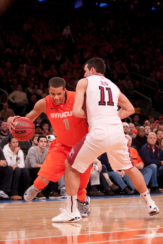 Michael Carter-Williams attempts to drive past T.J. DiLeo in Syracuse's 83-79 loss to Temple Saturday afternoon.