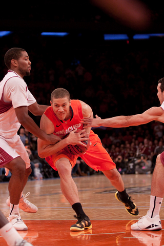 Brandon Triche shields the ball, driving. Triche was SU's second-leading scorer in the loss with 17 points.
