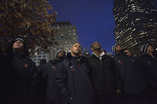 Syracuse cornerback Franklin Santos (43) and the rest of the Orange football team observes the 9/11 Memorial Thursday.