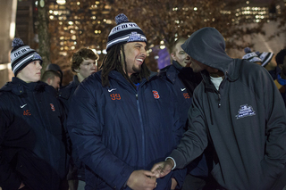 Syracuse defensive tackle Zian Jones laughs as the football team views the 9/11 Memorial.