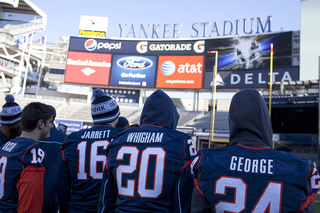 From left: James Jarrett, Julian Whigham and Jaston George stand on the field Friday at Yankee Stadium, one day before SU takes on West Virginia in the Pinstripe Bowl.