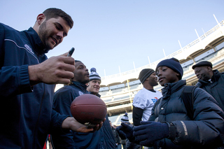 Offensive lineman Justin Pugh signs an autograph at Yankee Stadium Friday.