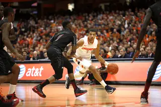 Syracuse point guard Michael Carter-Williams attempts to dribble around Cincinnati guard Cashmere Wright in the first half.