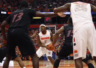 Syracuse small forward C.J. Fair is stopped by defenders at the top of the key during the second half.