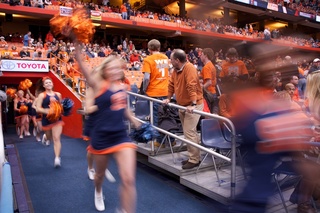 SU cheerleaders lead the Orange onto the floor.