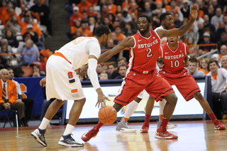 James Southerland looks to dribble past Rutgers forward Dane Miller.