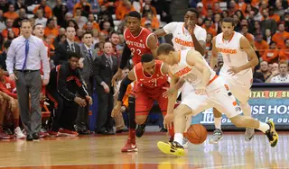 Brandon Triche fights for a losse ball with Rutgers guard Myles Mack.