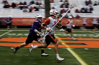 Syracuse defender Sean Young carries the ball through the midfield.