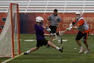 Syracuse attack Dylan Donahue fires a shot into the back of the net for one of Syracuse's 16 goals against Holy Cross.