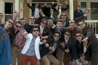 Fraternity brothers gather on Walnut Place to join in celebrations of sorority bid day. 