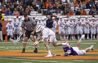Chris Daddio wins a faceoff against Albany's Kevin Glueckert in SU's loss to Albany Sunday evening in the Carrier Dome. Daddio set career records in faceoffs won, 20, attempted, 33 and ground balls, 8.