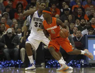 C.J. Fair drives at SHU's Kevin Johnson in Saturday night's SU victory at the Prudential Center in Newark, N.J.