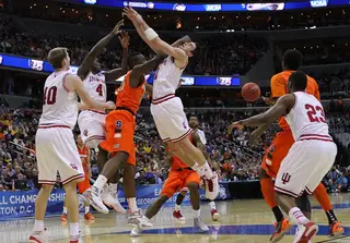 Will Sheehey #0 of the Indiana Hoosiers drives to the basket as he is blocked by Rakeem Christmas #25 of the Syracuse Orange.
