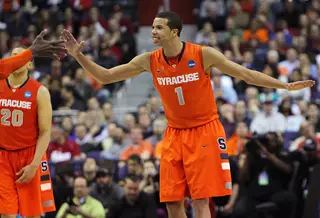  Michael Carter-Williams #1 of the Syracuse Orange high fives with teamates as the celebrate after a play against the Indiana Hoosiers.