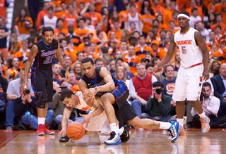 Michael Carter-Williams dives for a loose ball after DePaul guard Brandon Young lost control. Carter-Williams finished the game with 4 steals.