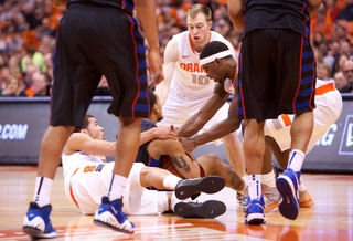 Michael Carter-Williams and C.J. Fair hustle to control a loose ball from DePaul guard Brandon Young.