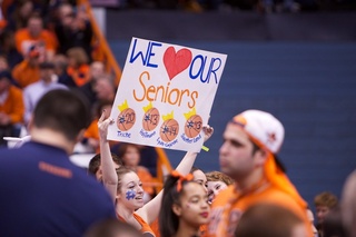 An SU fan displays a poster in support of the four Syracuse seniors on Senior Night.