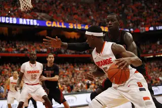 C.J. Fair dribbles the baseline against Louiville's Gorgui Dieng in the Orange's 58-53 loss to the No. 12 Cardinals in the Carrier Dome Saturday afternoon.
