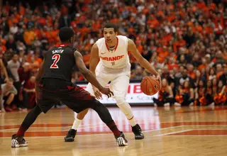 Michael Carter-Williams runs the Syracuse offense from the point against Russ Smith. 
