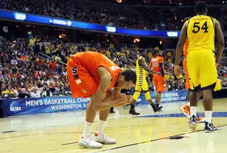  Michael Carter-Williams #1 of the Syracuse Orange reacts on the court late in the game in front of Davante Gardner #54 of the Marquette Golden Eagles.