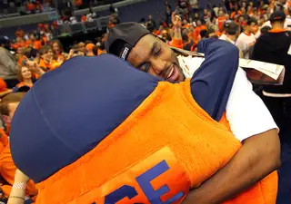 Rakeem Christmas #25 of the Syracuse Orange hugs Otto after the win over the Marquette Golden Eagles.