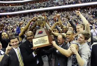 Head coach John Thompson III and Markel Starks cheer with teammates as they hold up the Big East regular-season championship trophy.