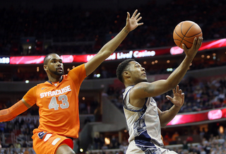 D'Vauntes Smith-Rivera puts the ball up to the basket as James Southerland tries to catch up for the block.