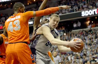 Nate Lubick (34) of the Georgetown Hoyas drives to the basket against James Southerland (43) and Rakeem Christmas.