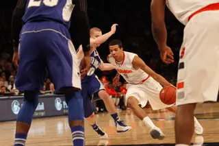 Michael Carter-Williams drives leftaround Kyle Smyth. Carter-Williams tied a Big East tournament assist record with 14. His mark equaled that of former Orangeman Pearl Washington, who was in attendance Wednesday afternoon.