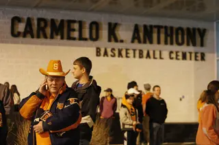 Dick Woodworth (far left), a Syracuse resident, waits at the Carmelo K. Anthony Basketball Center late Saturday for the arrival of the Syracuse Men's Basketball team.