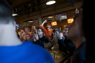 John Jargin, a senior math education major, cheers inside Faegan's Pub during the Syracuse vs. Marquette matchup.