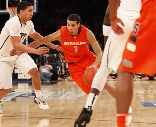 Michael Carter-Williams drives the ball down the court past Pittsburgh's James Robinson (#0).