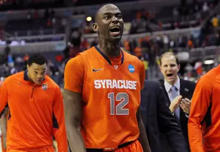 Baye Moussa-Keita #12 of the Syracuse Orange celebrates with teamates after a win over the Indiana Hoosiers.