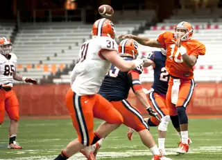 Syracuse quarterback Terrel Hunt throws over defensive tackle Lucas Albrecht.