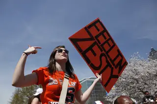 Evelyn Burgess, a freshman at Syracuse University, taunts Michigan fans in Centennial Park.