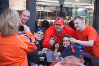 Syracuse fans flock to The Hudson Grille with friends and family to cheer on the Orange the day before their matchup against Michigan.