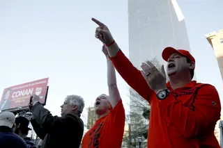 Kevin Thomas (right) and AJ Thurlow (left) of Herkimer, N.Y., cheer on the Sour Sitrus Society and Syracuse University cheerleaders outside of The Hudson Grille.