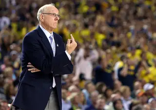 Head coach Jim Boeheim of the Syracuse Orange gestures towards the court in the game against the Michigan Wolverines.