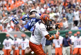 A Syracuse players battles Duke's Brendan Fowler for possession. Fowler won 20-of-28 faceoffs for the Blue Devils.